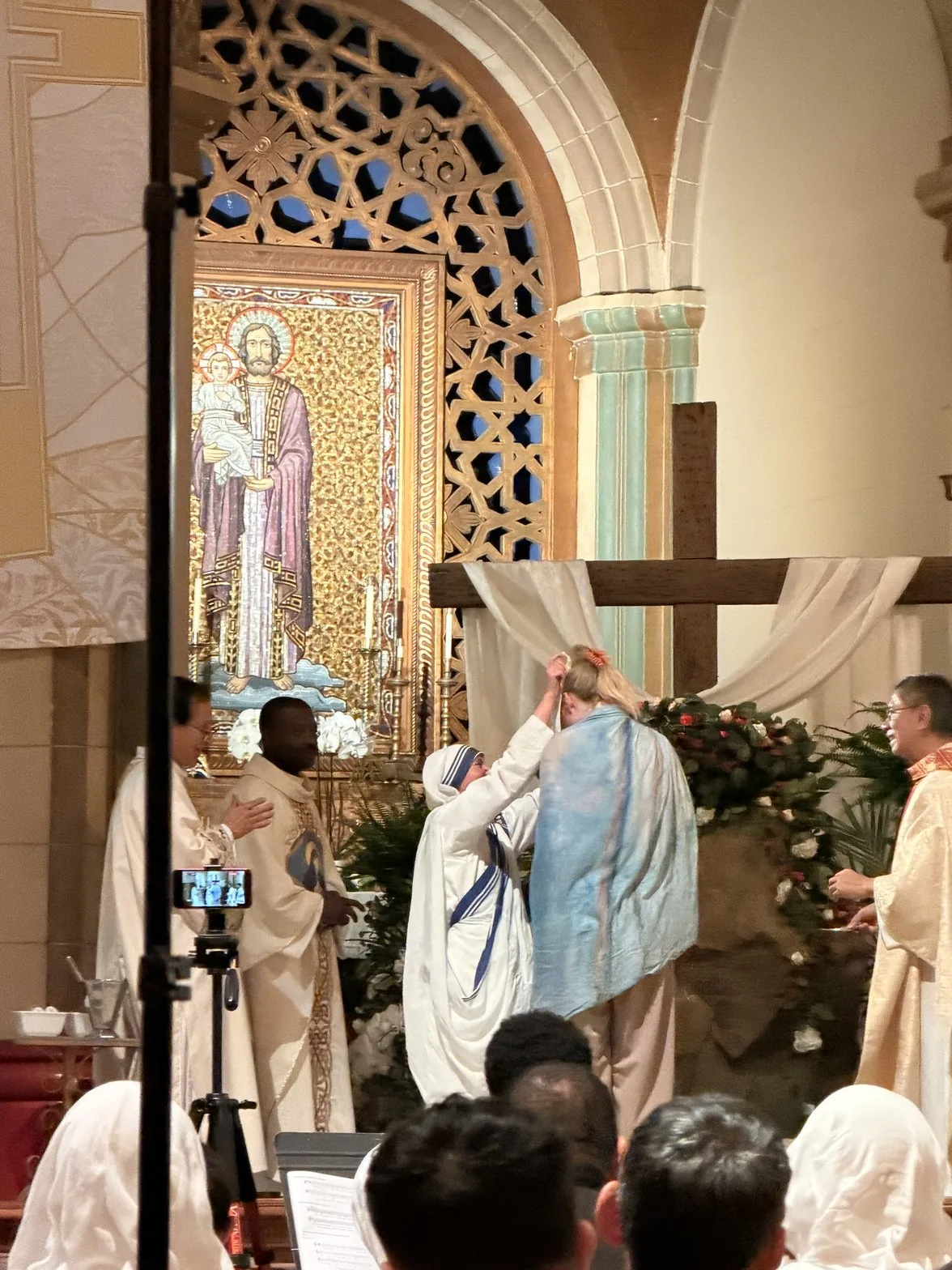 Sue from behind during her baptism at the altar wearing the Monet shawl